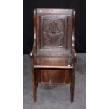 An oak hall armchair, constructed from period timbers, floral scroll panel back, chip carved arms