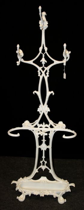 A Victorian, later refurbished cast iron coat/stick stand with three entwined scrolled branches,