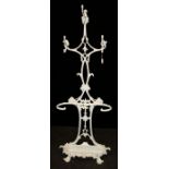 A Victorian, later refurbished cast iron coat/stick stand with three entwined scrolled branches,
