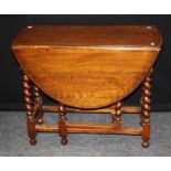 A 1920's oak drop leaf gateleg dining table, on barley twist and block supports. 72 x 90 x 124cm (
