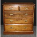 An Edwardian field walnut chest, the rectangular top over two short and three graduated long