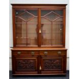 An Edwardian walnut library bookcase, the moulded cornice over a pair of half - astragal glazed