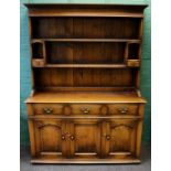 A reproduction 18th century style oak tall dresser, the rack with two open shelves, pigeon holes and