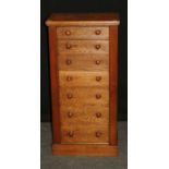 A Victorian oak Wellington chest of seven graduated mahogany lined drawers with knop handles, on