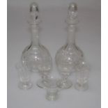 A pair of Edwardian facet cut decanters and stoppers, 31cm, four early 19th century drinking glasses