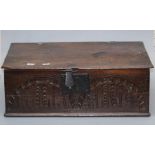 A carved oak Bible box of typical form, the oblong rising top over a carved front frieze, 17th