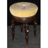 An Edwardian mahogany piano stool with candle and patchwork lemon upholstered circular adjustable