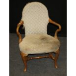 An early 20th century walnut framed Queen Anne style tapestry upholstered open armchair, on cabriole