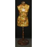An Edwardian dress makers mannequin with decoupage decoration and turned wood stand