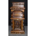 A 19th century oak coal purdonium, the shelved back over fruiting urn carved fall on plinth, 100 x