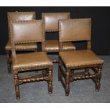 A set of four early 20th century oak dining chairs with close studded hide upholstered back and over