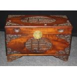 A mid 20th century carved camphor wood trunk, decorated with reserves of pagodas and landscapes,