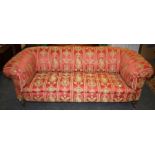 An early 20th century walnut framed Chesterfield settee upholstered in red neo classical style