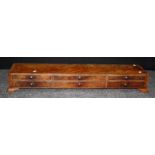 A bank of six early 19th century mahogany, crossbanded and strung dressing table drawers each with