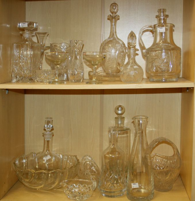 A mixed lot of cut and moulded glassware, including spirit and other decanters, water jug, two