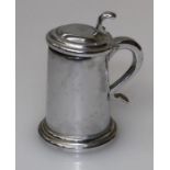 A Dunhill chrome plated table lighter fashioned as a lidded tankard with domed cover, scrolled