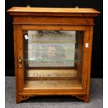 An Edwardian oak wall mounting dentists cabinet, the glazed door named D Gore Boodle and Co. Ltd,