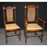 A set of six early 20th century oak dining chairs, each having scrolled rail, cane upholstered back,