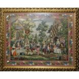 A large gilt framed and glazed woolwork of figures making merry outside a tavern, within a