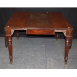 A William IV 'fiddleback' mahogany extending dining table, the rectangular top and twin flaps with