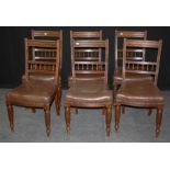 A set of six Edwardian walnut dining chairs, each having channeled rail, spindle splat hide