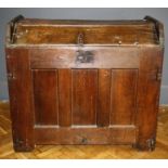 An early 18th century oak ark or meal chest, the planked dome top with iron furniture over three