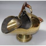 A Victorian brass 'helmet' shape coal scuttle, with turned wood handles, tin liner and an associated
