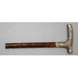 An Edwardian silver scroll chased parasol handle with simulated cane shaft, London marks indistinct,