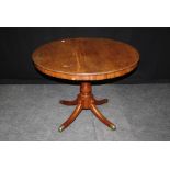 A mahogany breakfast table. the circular snap top laid on quadruple splay legs, 10cm diameter