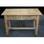 A 20th century constructed limed oak kitchen dining table, the planked top over two frieze