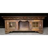 A Victorian oak wall cupboard, the rectangular top over a florally carved frieze and shelf flanked