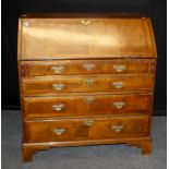 A George III mahogany bureau, the moulded edge fall enclosing a fitted interior over four
