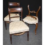 A pair of late George III mahogany dining chairs, the cresting rails above overstuffed seats and