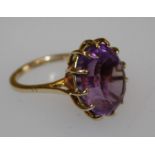 A 9k amethyst ring, claw set large oval cut amethyst, hallmarked, sponsors mark RMP. 7.0g