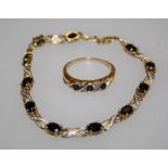 A 9ct gold tennis type bracelet set with eleven cushion cut sapphires and diamond chips with pierced