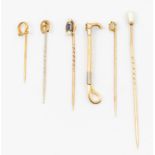 A collection of vintage stick pins to include a sapphire and pearl set 15ct gold stick pin, along