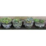 A set of four reconstituted stone planters, each with fruiting swag decoration. 32 x 52cm