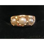 A 15ct pearl ring, gypsy set three graduated cultured pearls, 4.8g