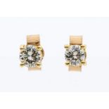 A pair of 9ct gold and diamond stud earrings, claw set with round brilliant cut diamonds, total