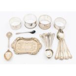A collection of silver to include four napkin rings and teaspoons, various dates and makers, 8.86