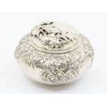 An early 20th Century American silver caddy / bowl and cover, the body chased with foliate