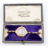 An early 20th century 9ct rose gold cased ladies watch with round silvered dial, Arabic numerals,