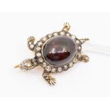 An Edwardian style garnet and diamond set brooch in the form of a Turtle, central cabochon garnet