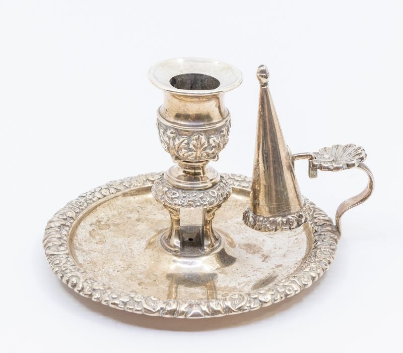 A George III silver chamberstick and snuffer, the borders with profuse floral and foliate