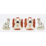 A pair of Victorian Staffordshire pottery spaniel head money boxes and a pair of Staffordshire