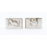 A matched pair of Modern silver napkin rings, with Squirrel and Otter silhouette decoration,