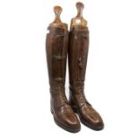 Equestrian interest; a pair of early 20th Century gents riding boots, leather, along with a wooden