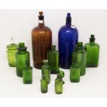 A collection of cobalt blue, green and amber apothecary bottles, various sizes including two large