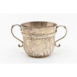 A Queen Anne Britannia standard silver two handled porringer, rope twist band above wyvern fluted