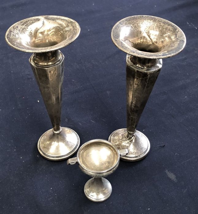 Two weighted silver vases (18cm high) hallmarks rubbed, together with a silver miniature trophy